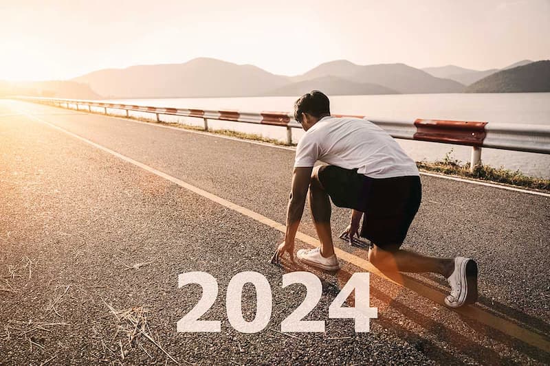 Man getting ready to run on a street with 2024 overlayed over the image
