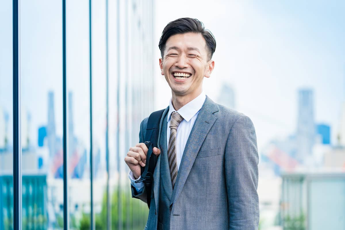 A happy businessman smiling widely