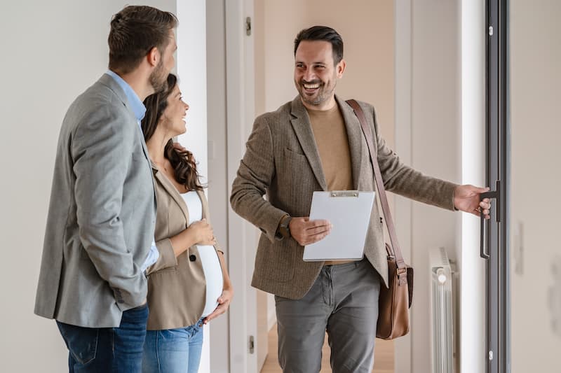 Insurance agents meeting in an office hallway