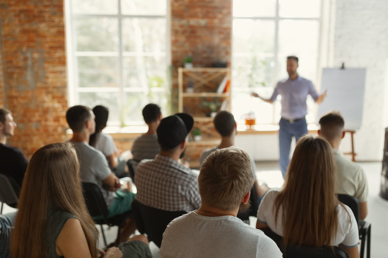 a person standing in front of a group of people