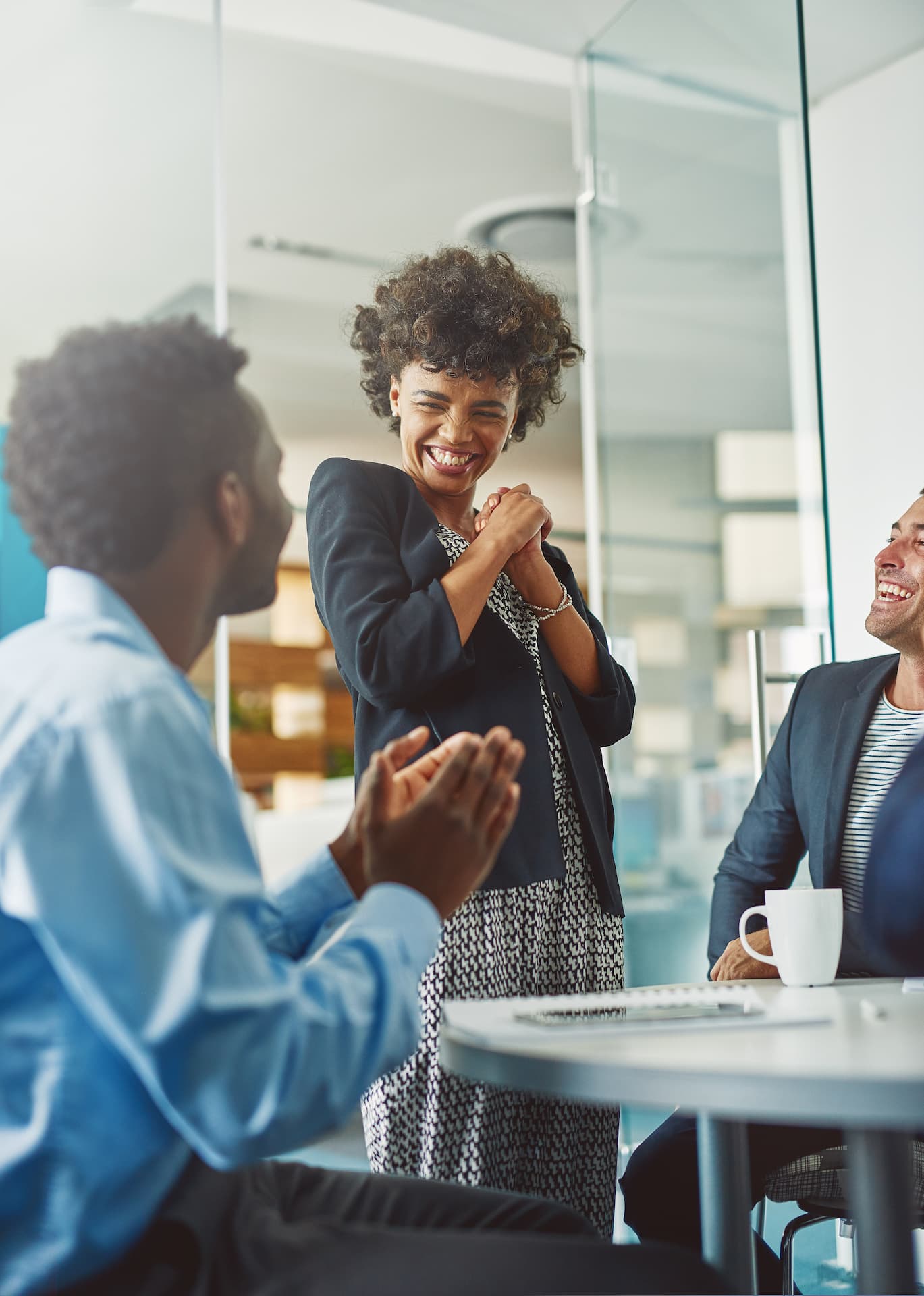 An employer talking and laughing with two of her employees