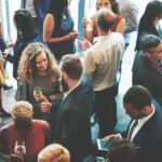 A crowd of people talking and networking